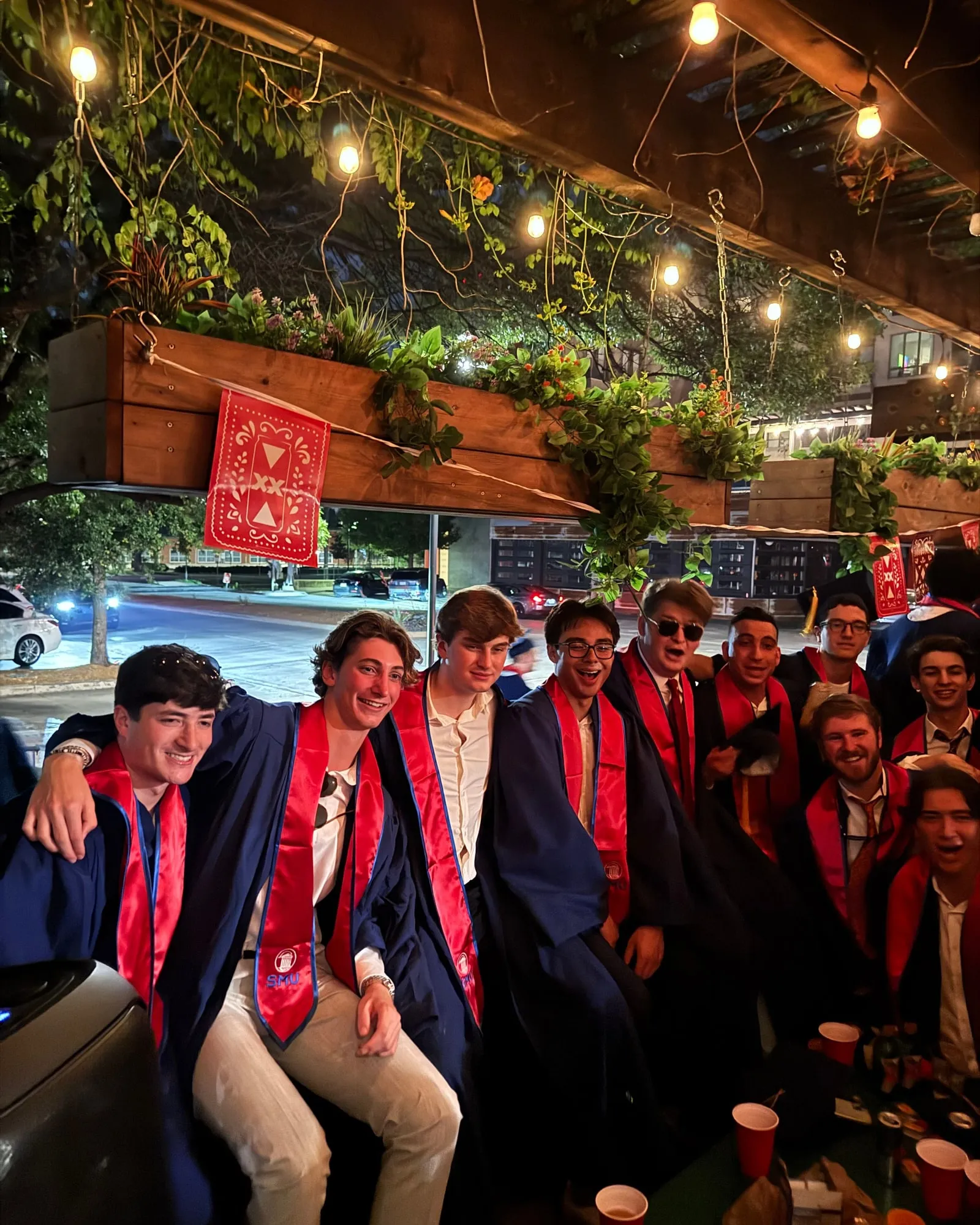 Graduating brothers of the Tau Chi Chapter in caps, gowns, and SMU honor stoles